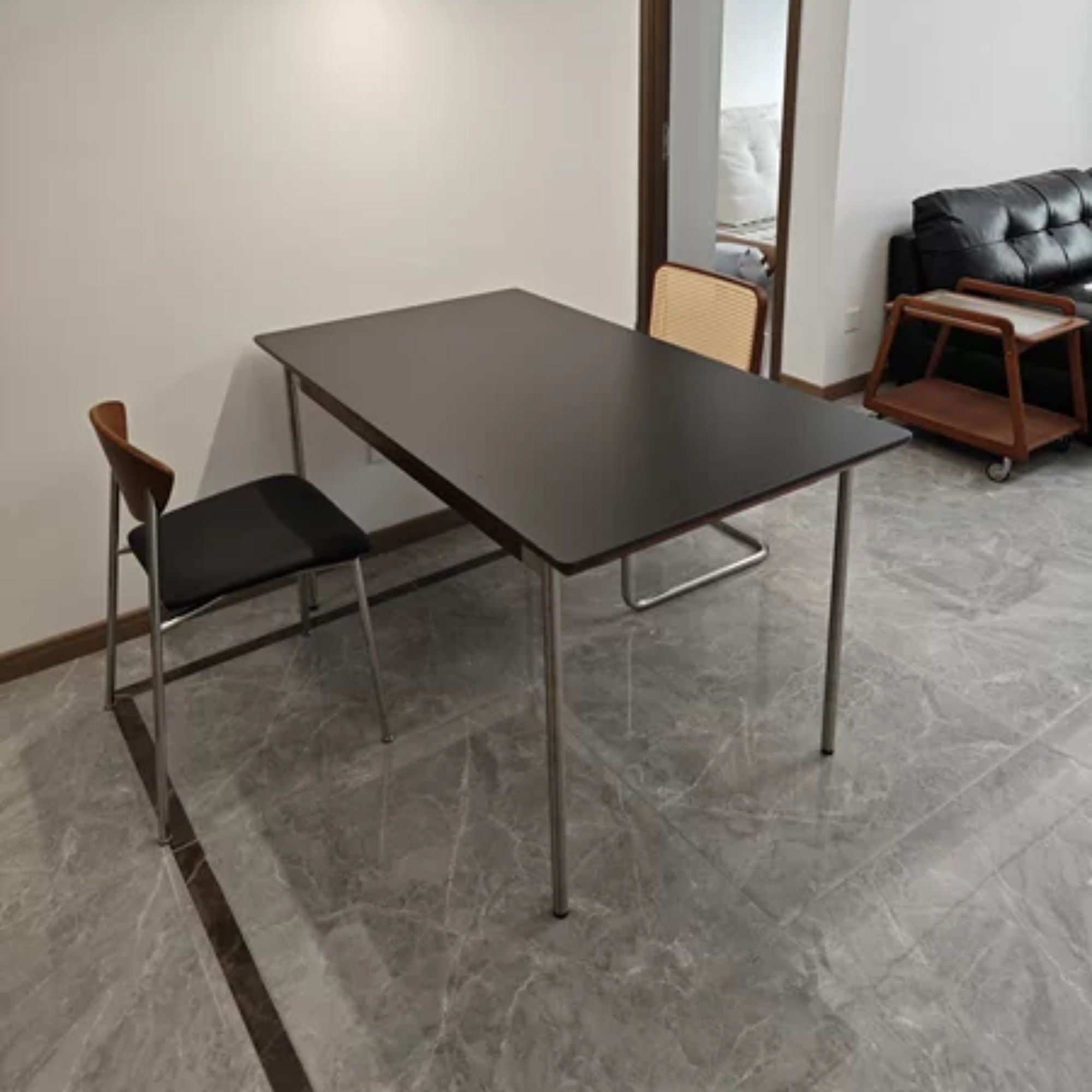 Taylor black sintered stone dining table in opening concept living room