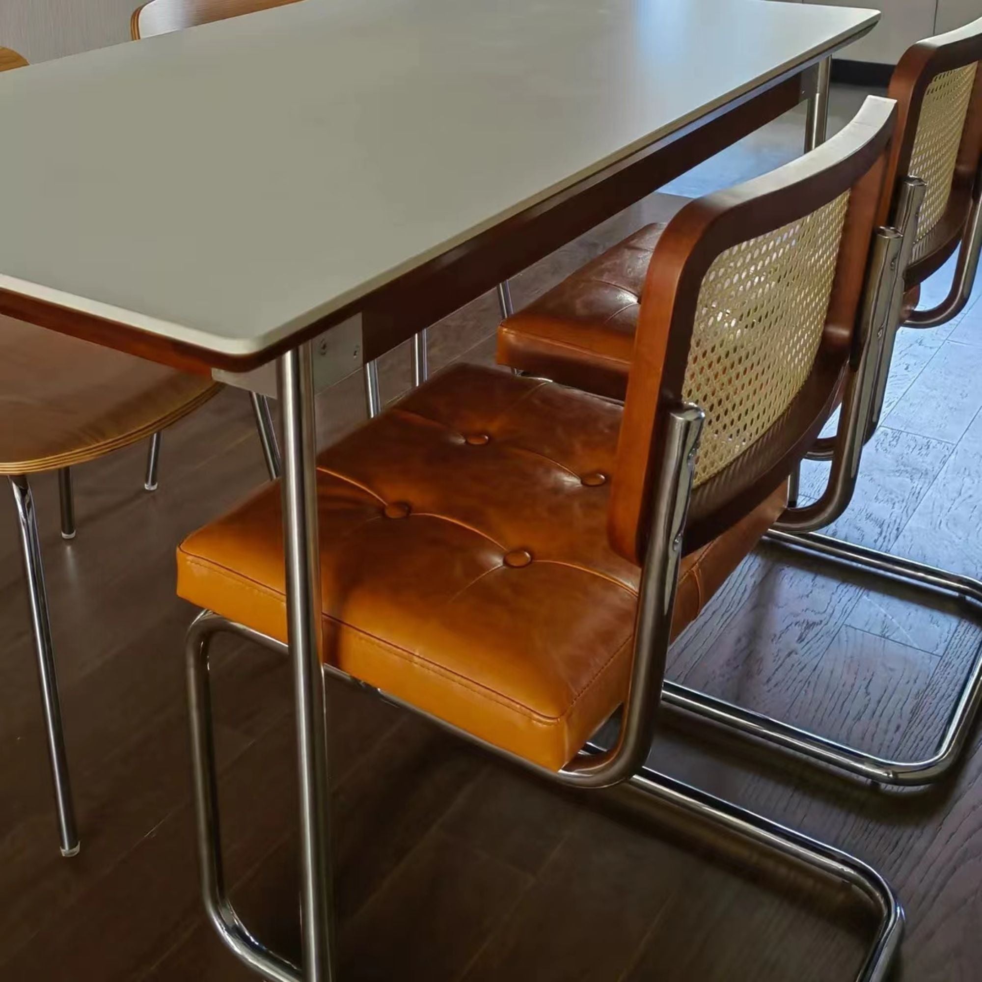 Side close up shot of Zephyr stainless steel chair used with dining table