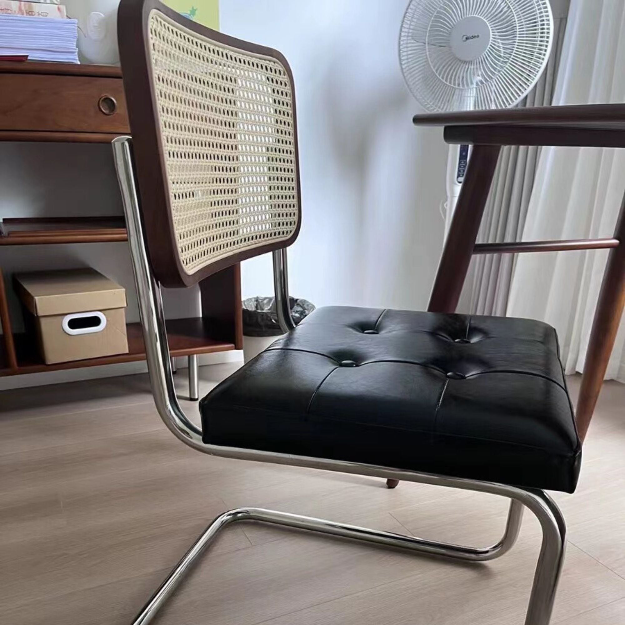 Side close up shot of Zephyr stainless steel chair in black