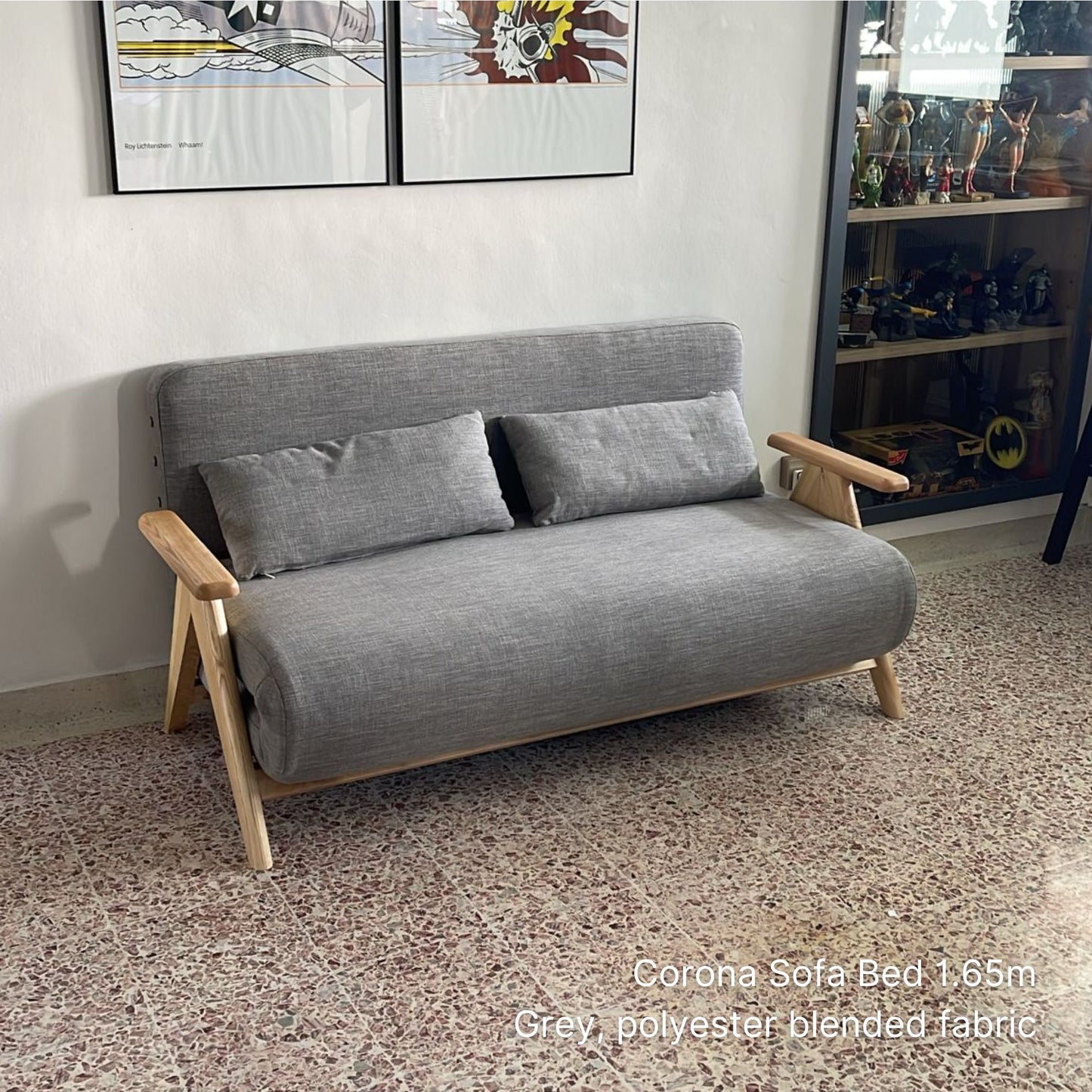 Gray sofa bed with wooden frame in a room setting