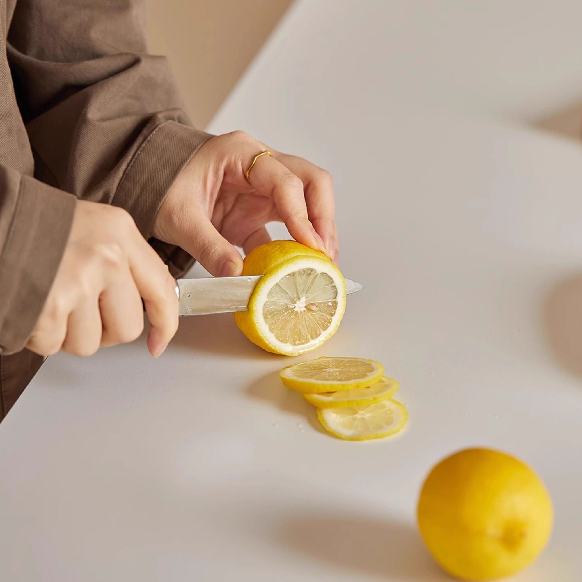 Cutting lemon on Trevor sintered stone dining table surface