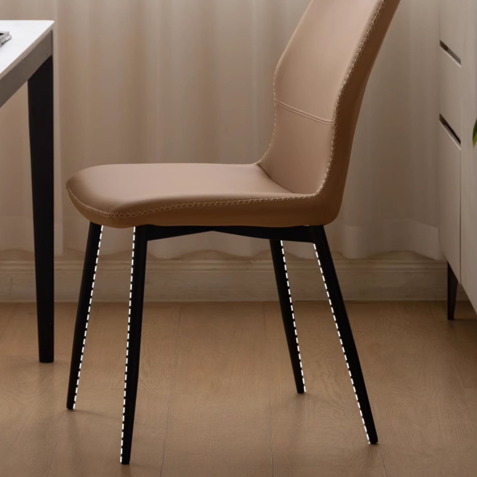 Brown chair with black legs in a room setting