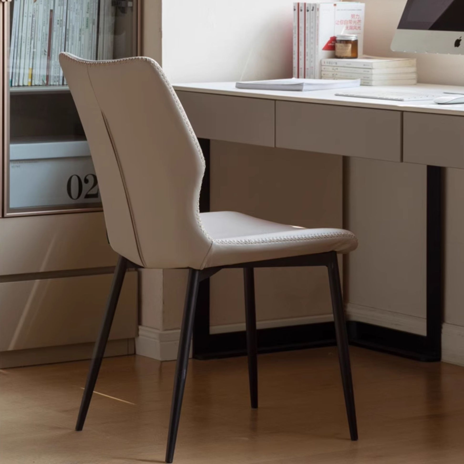 Grey chair in front of a desk with a computer setup