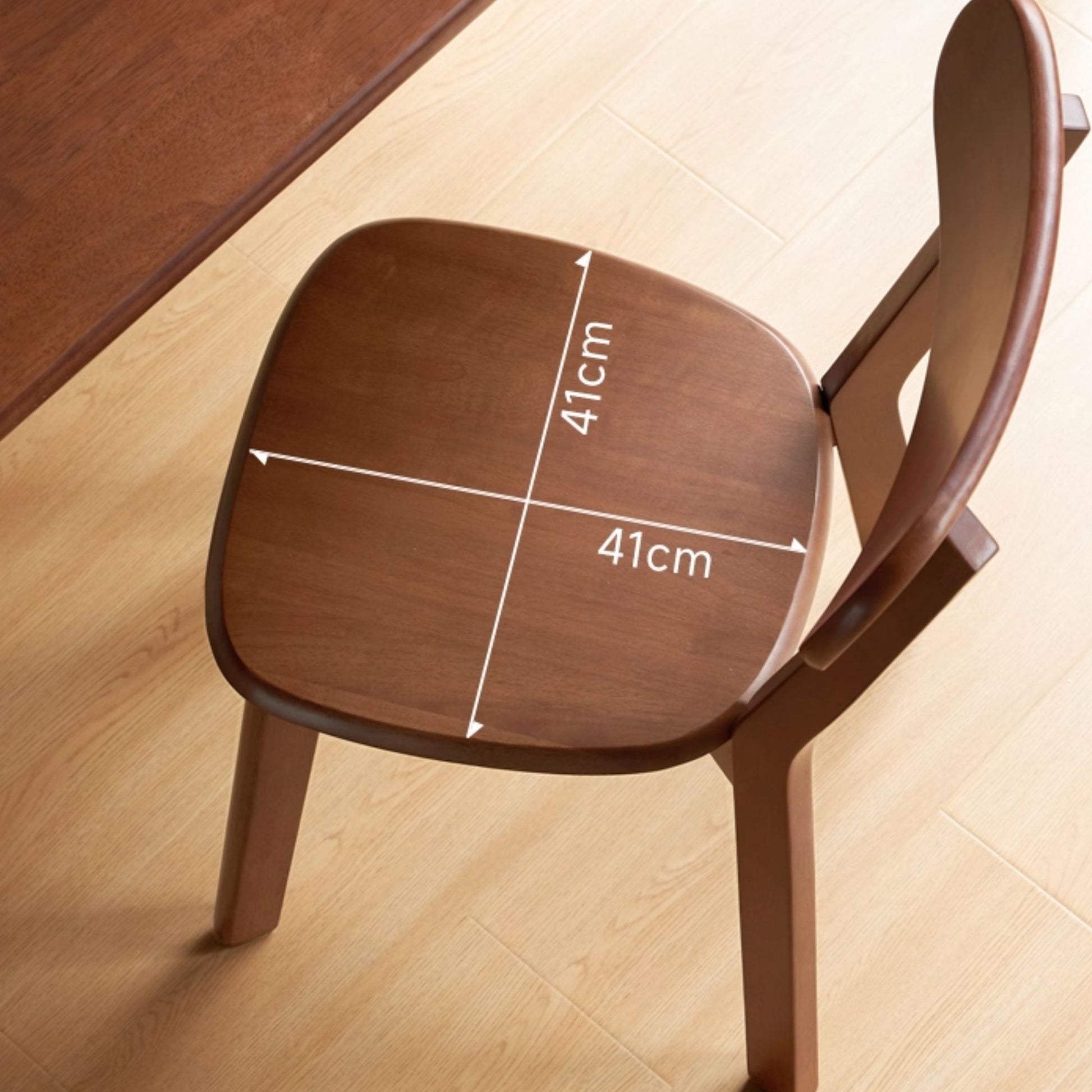 Wooden chair seat with measurements on a light wood floor