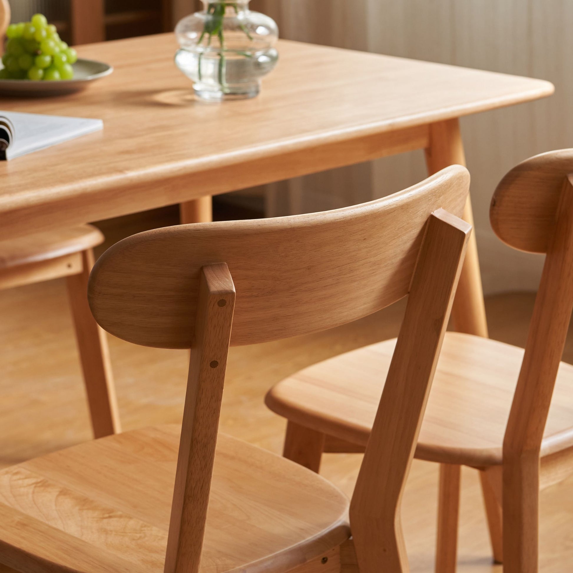 Wooden dining table with chairs in a room setting