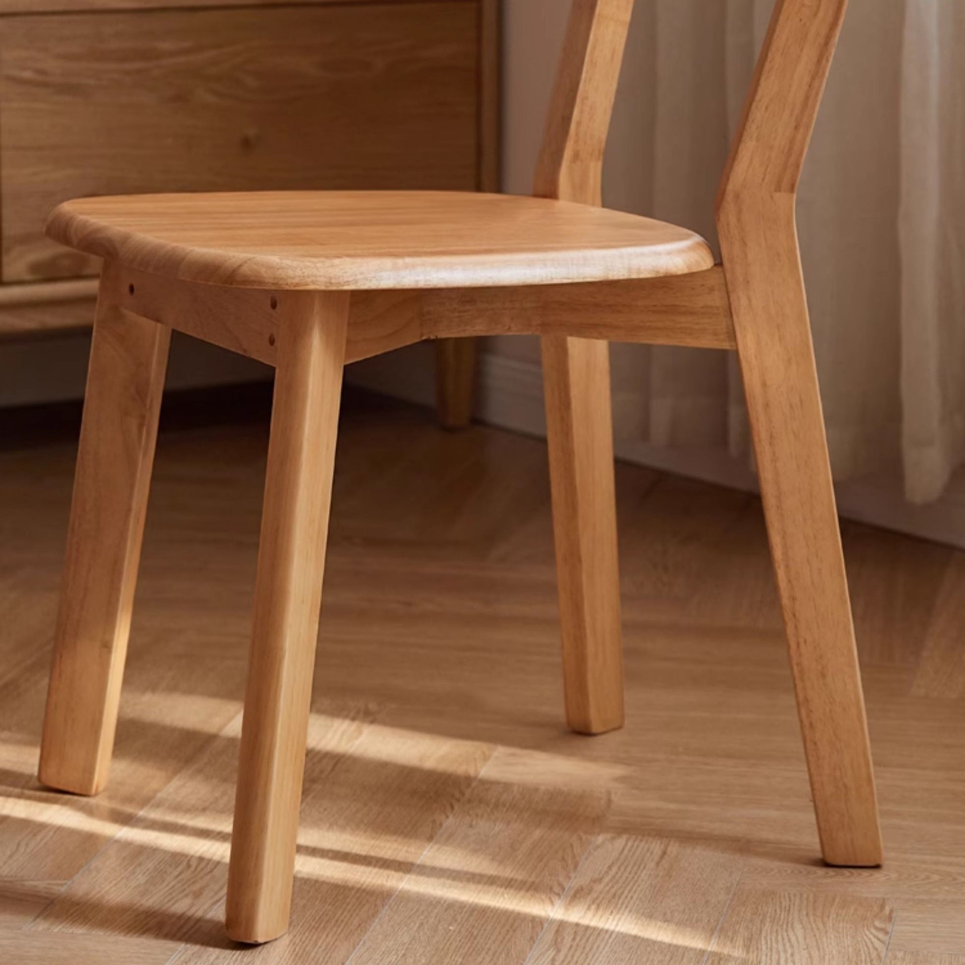 Wooden chair on a wooden floor with a neutral background