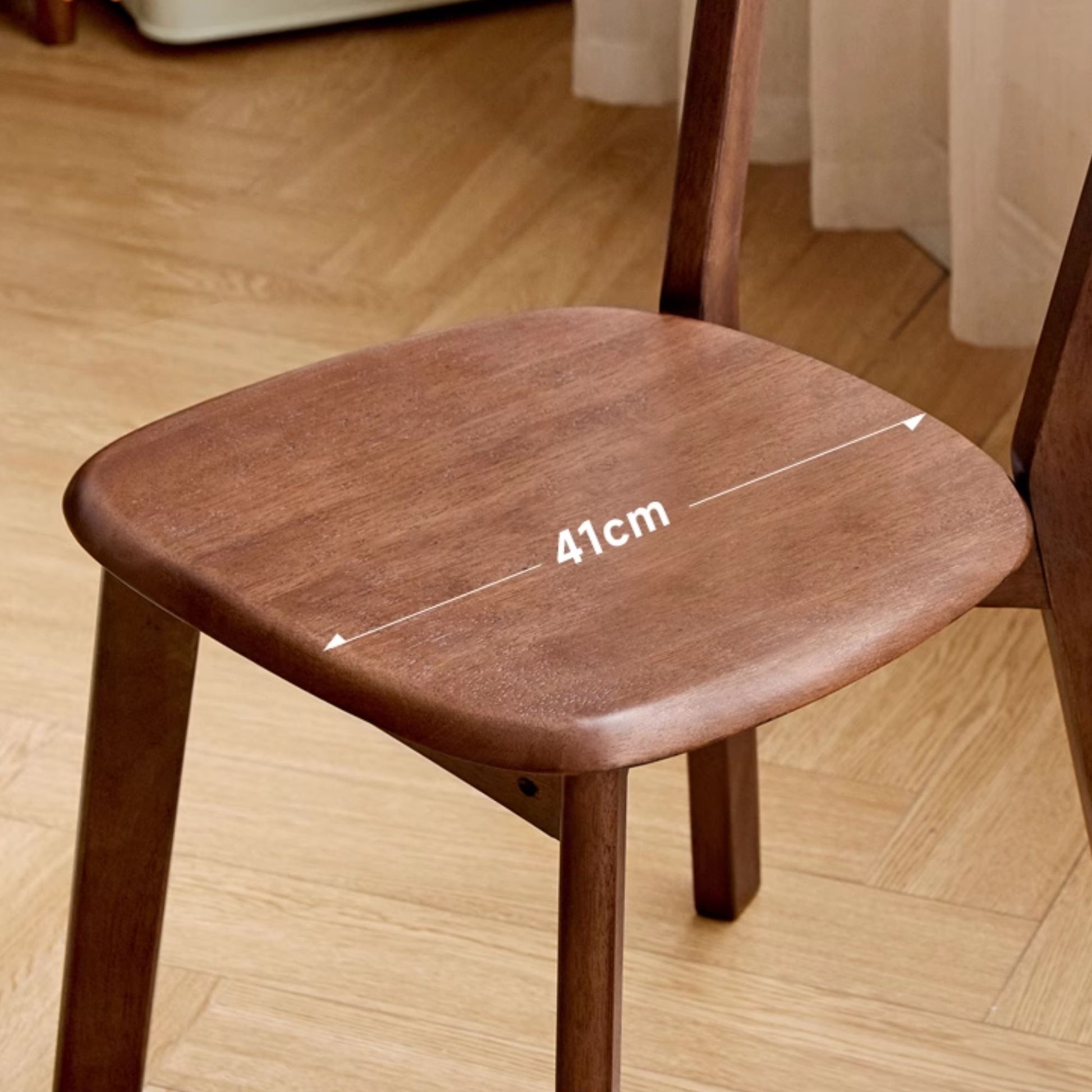 Wooden chair with measurement labeling the seat depth
