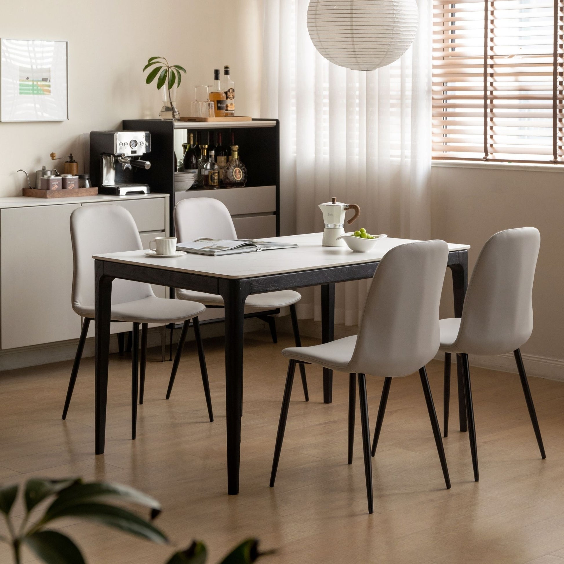 Dining area with a table and chairs in a modern kitchen.