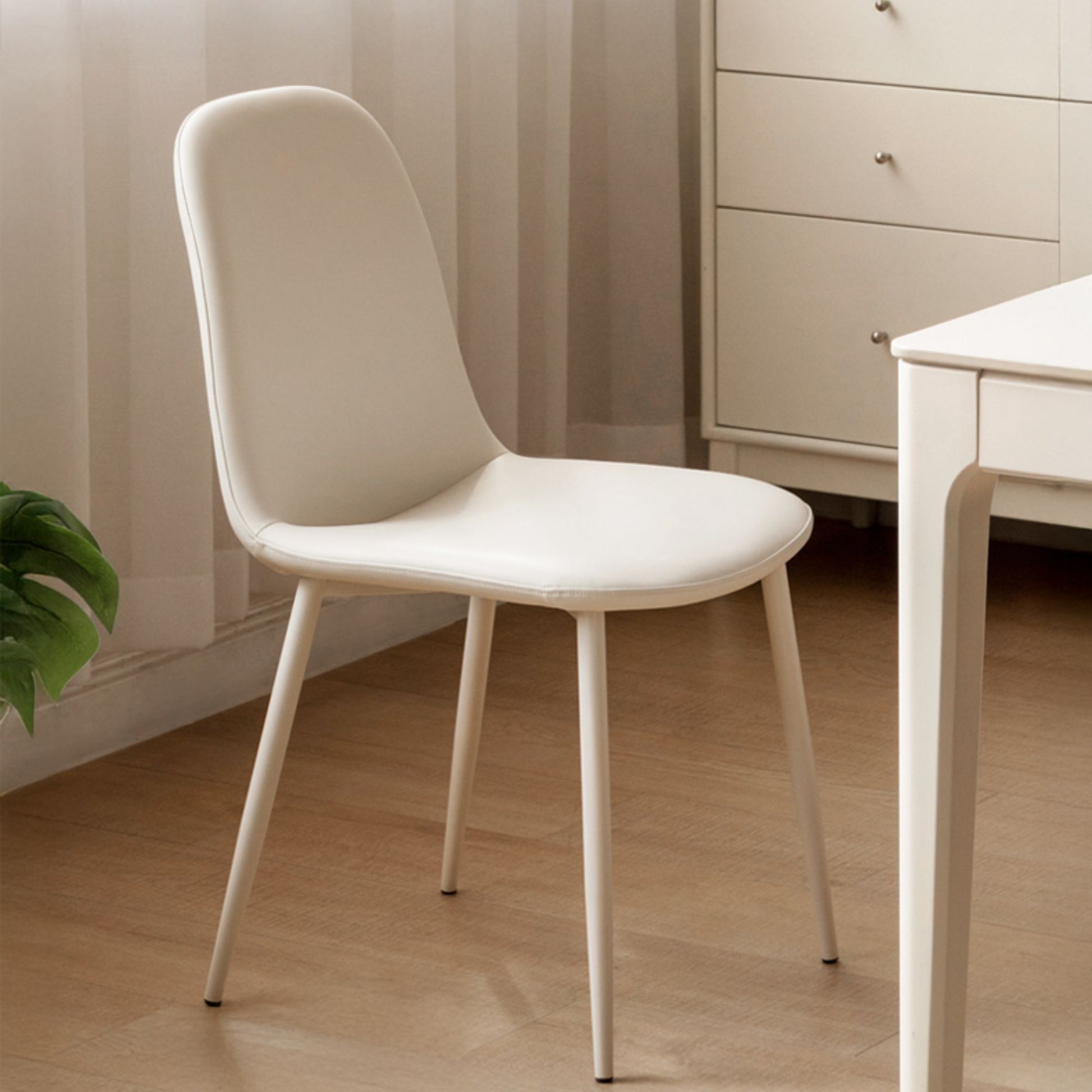 White chair in a room with a neutral color scheme