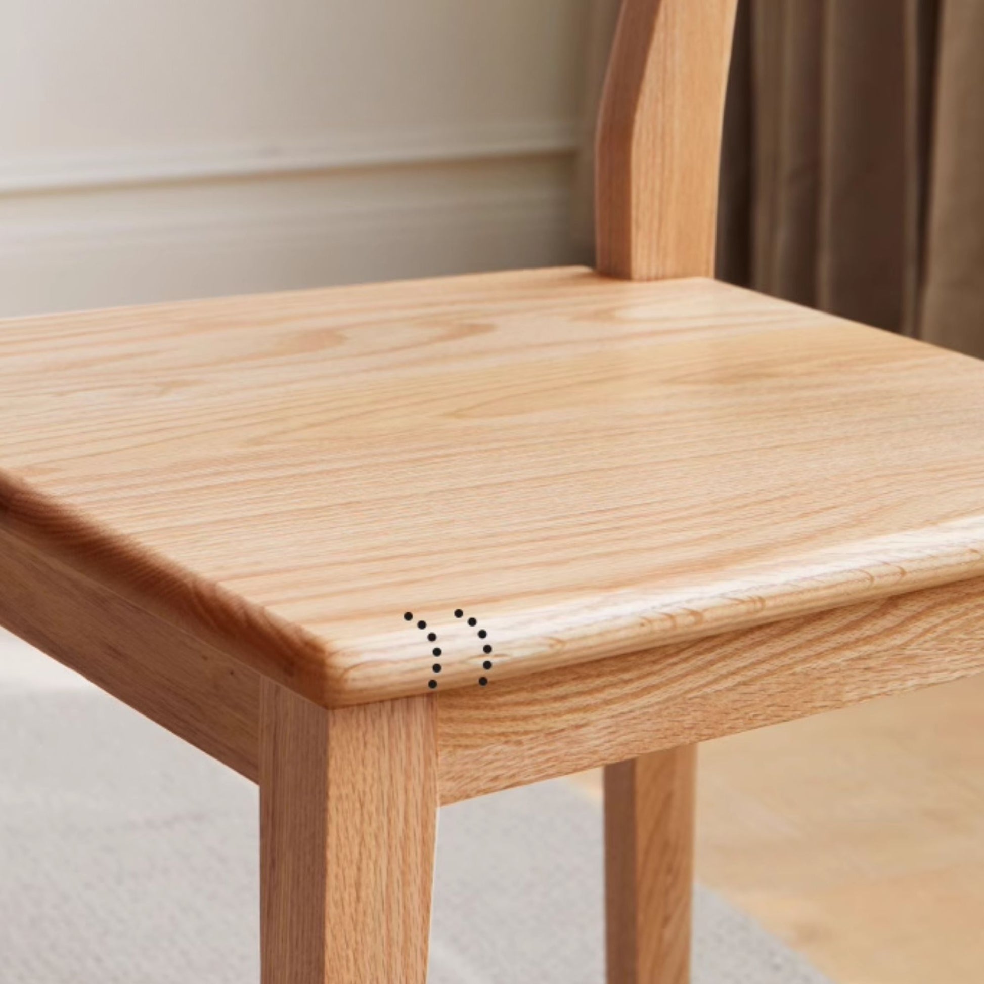 Wooden chair with a focus on the joinery details.