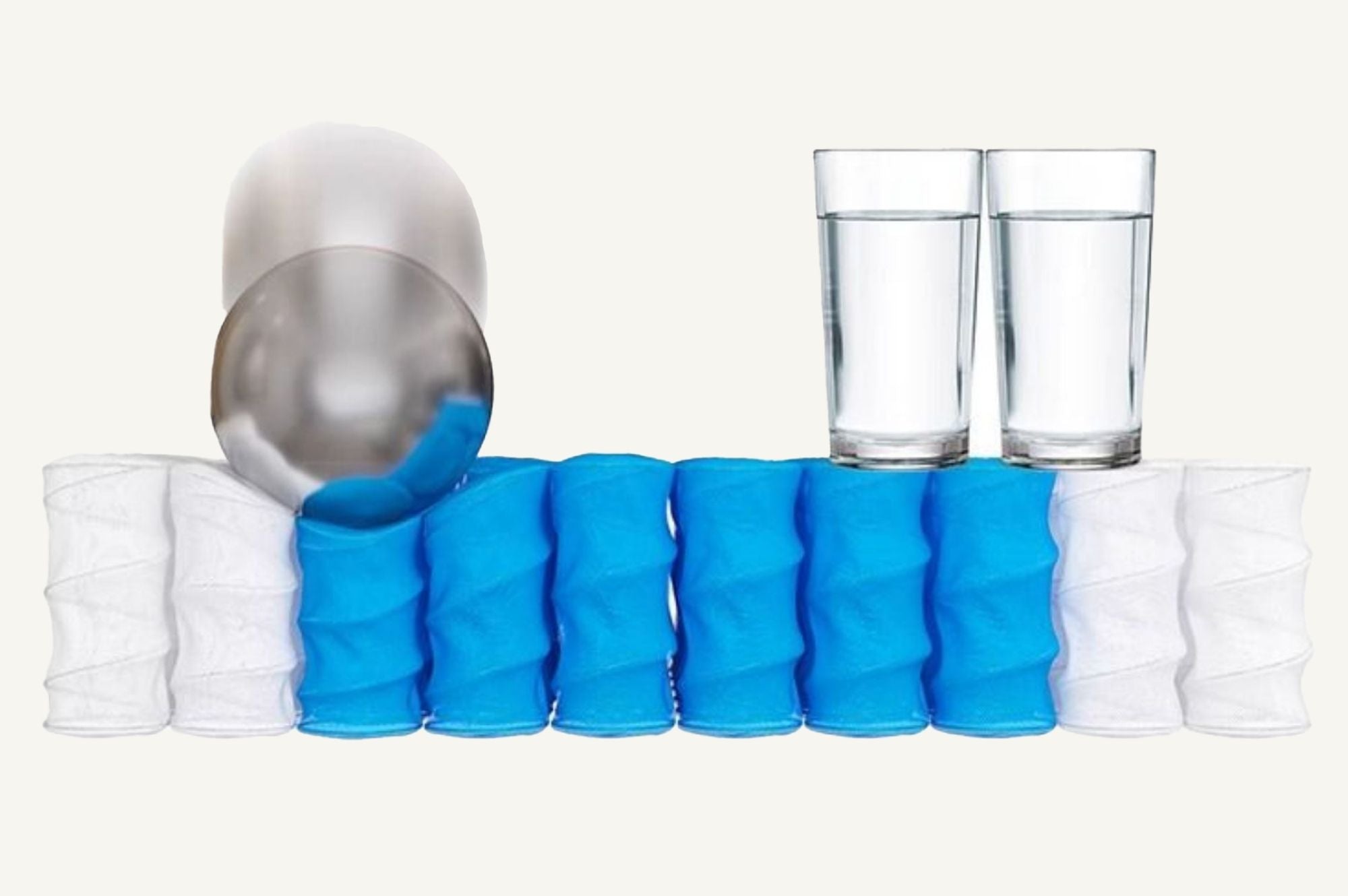 Picture showing a metal ball landing on individual pocket springs whilst the glass of water nearby remains stable