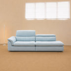 Light blue Calla One Arm Sofa with deep seats, a curved arm cushion and adjustable backrests shown at two heights at factory