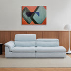 Light blue Calla One Arm Sofa with deep seats, a curved arm cushion and adjustable backrests shown at two heights.