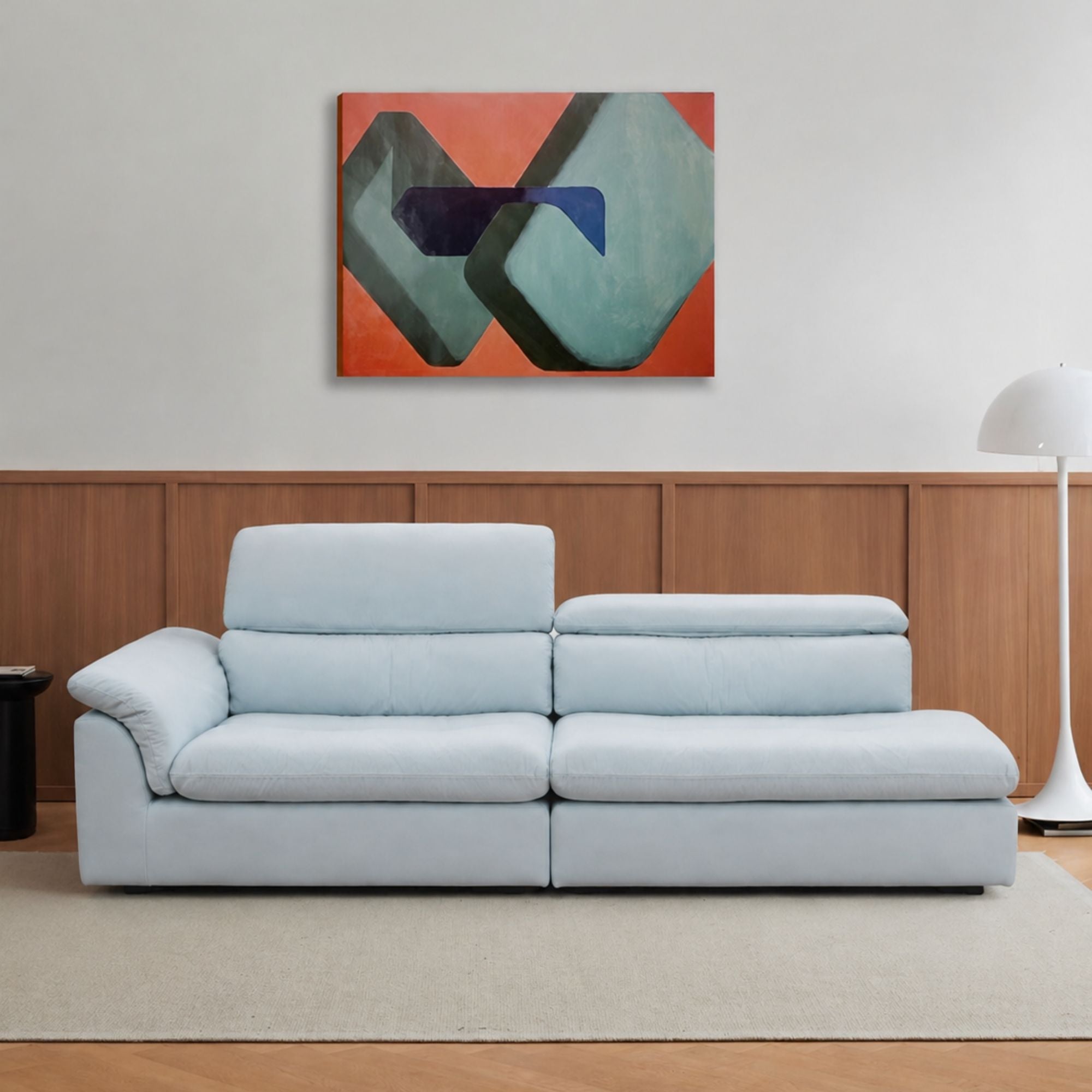 Light blue Calla One Arm Sofa with deep seats, a curved arm cushion and adjustable backrests shown at two heights.
