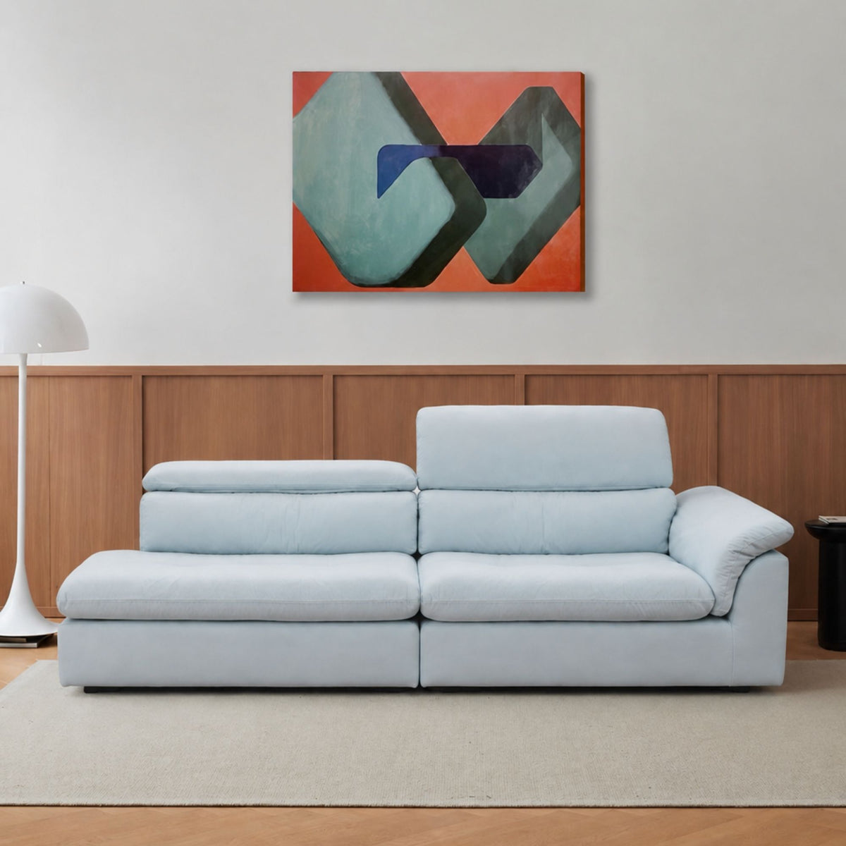 Light blue Calla One Arm Sofa with deep seats, a curved arm cushion and adjustable backrests shown at two heights.