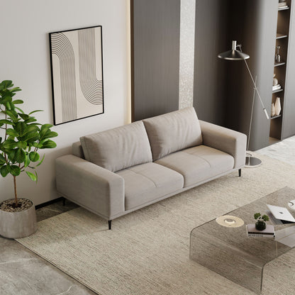 Modern living room with a gray sofa, coffee table, and decorative elements.