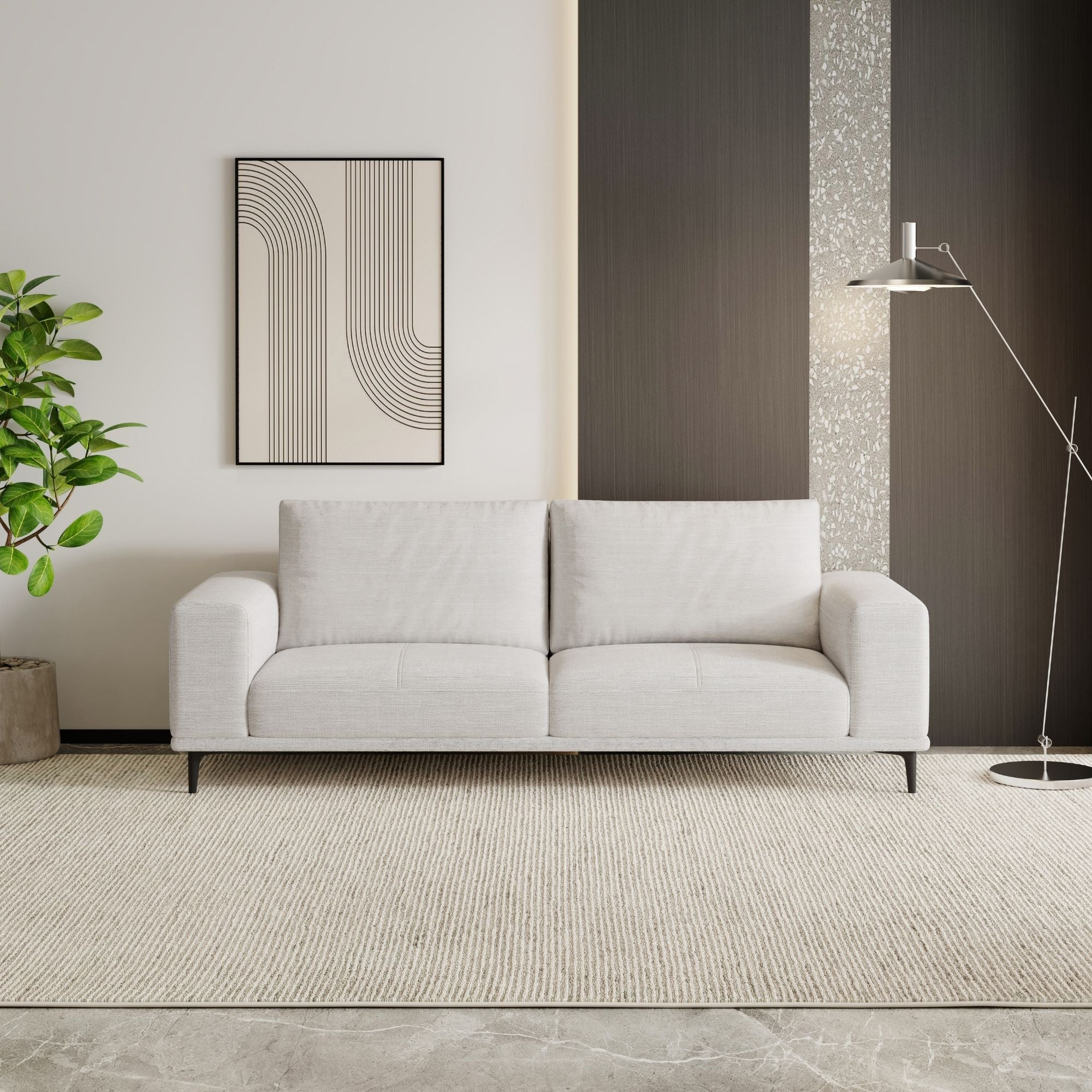 White sofa in a modern living room with a plant and abstract art on the wall.