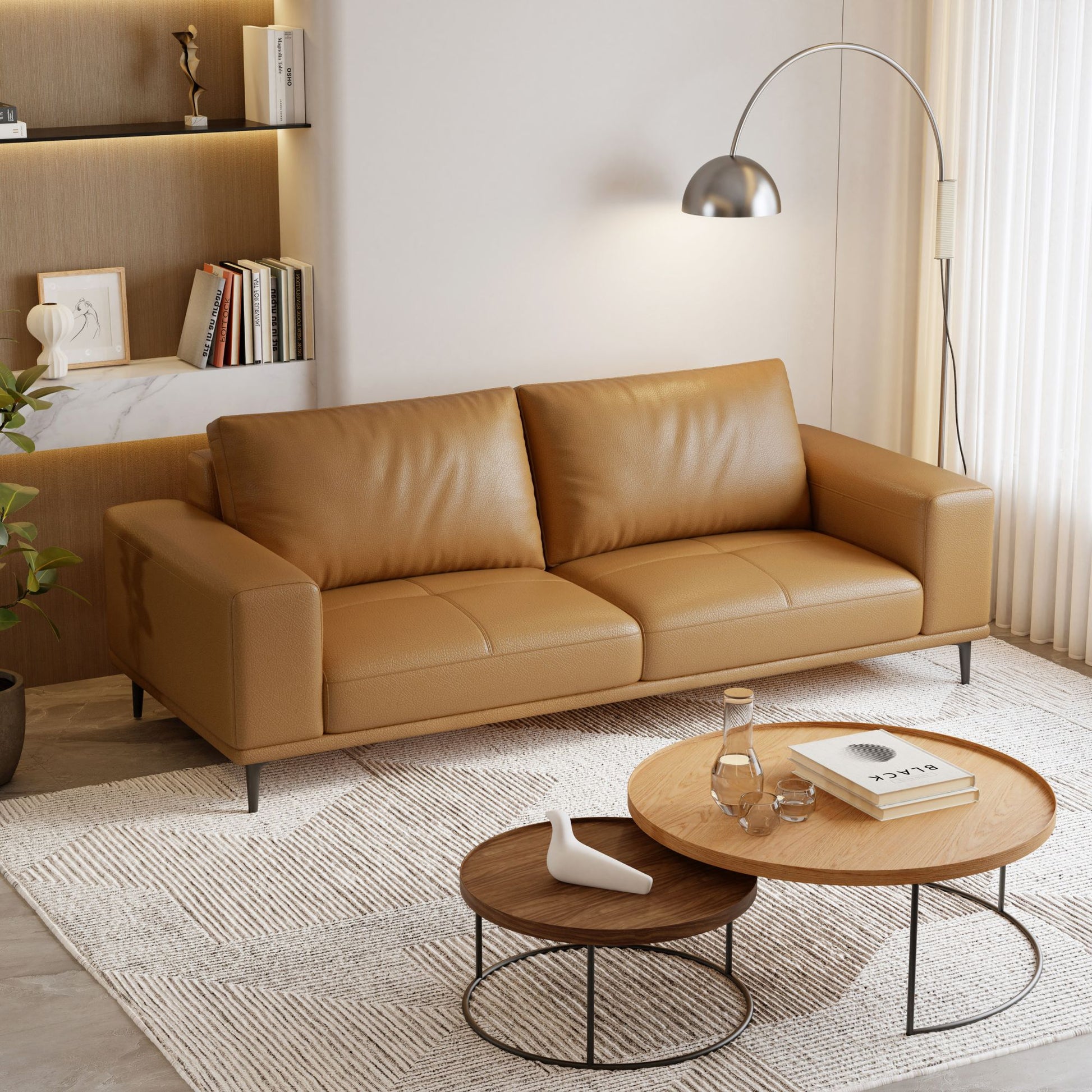 Brown leather sofa in a modern living room with coffee tables and decor.