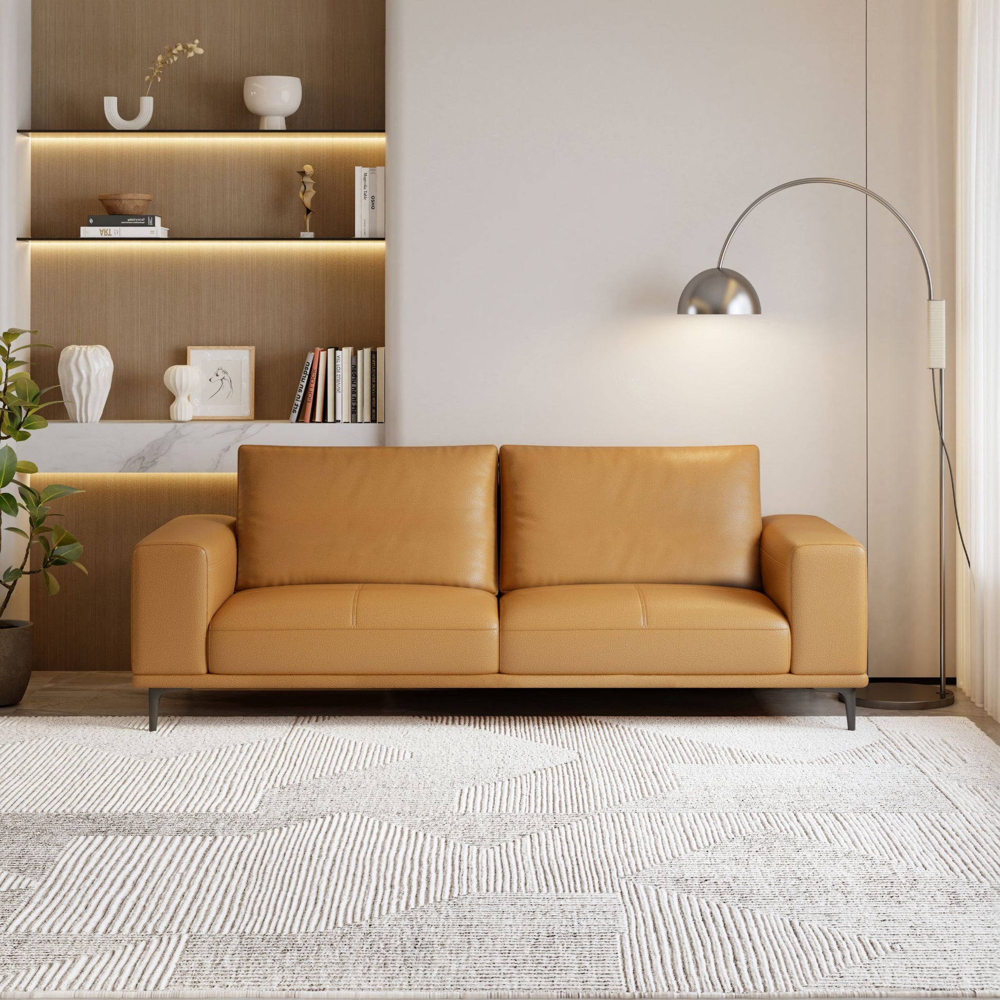 Tan leather sofa in a modern living room with a neutral color palette.