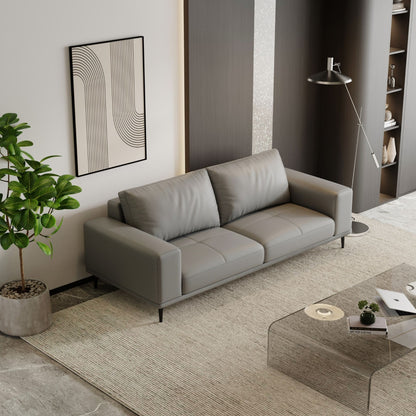 Modern living room with a gray sofa, coffee table, and decorative elements.