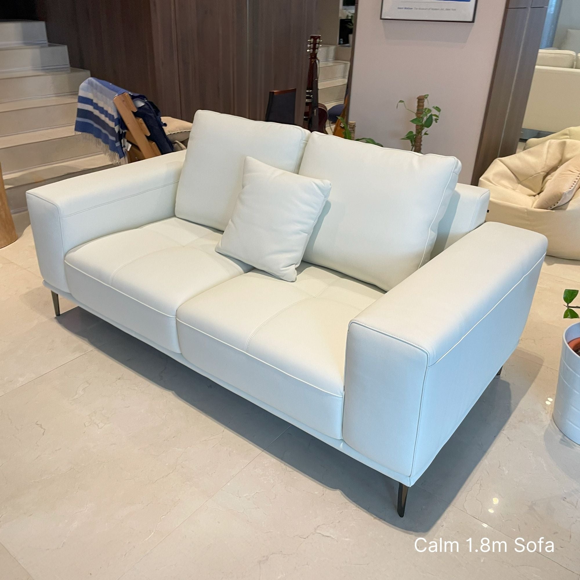 White sofa with cushions in a room setting