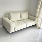 White sofa in a room with white walls and floor