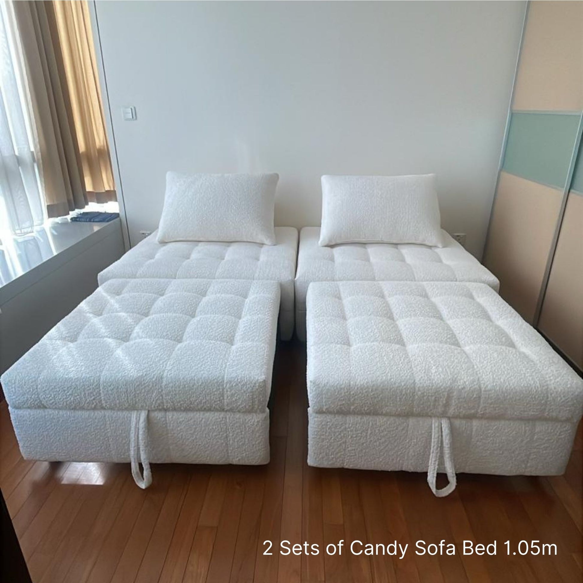 Two sets of Candy Sofa Bed 1.05m in a room with wooden flooring and a mirror.