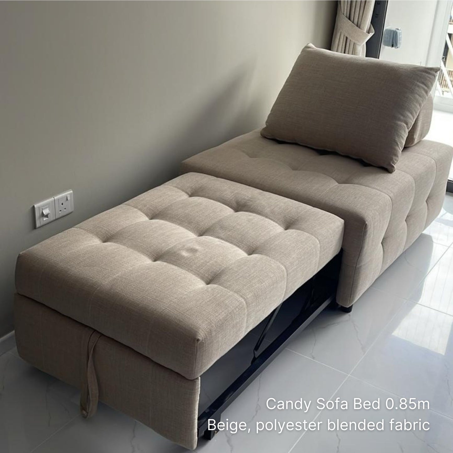 Beige sofa bed with a pillow in a room setting