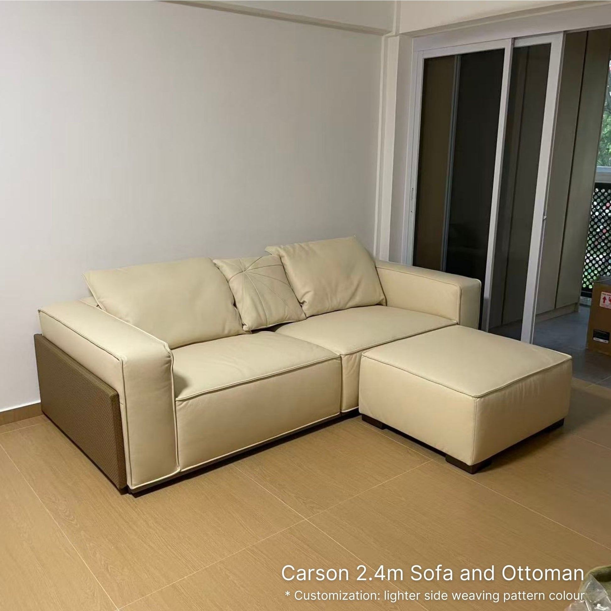 White 3 seater 240cm Carson half leather sofa with ottoman in a room with sliding glass doors.