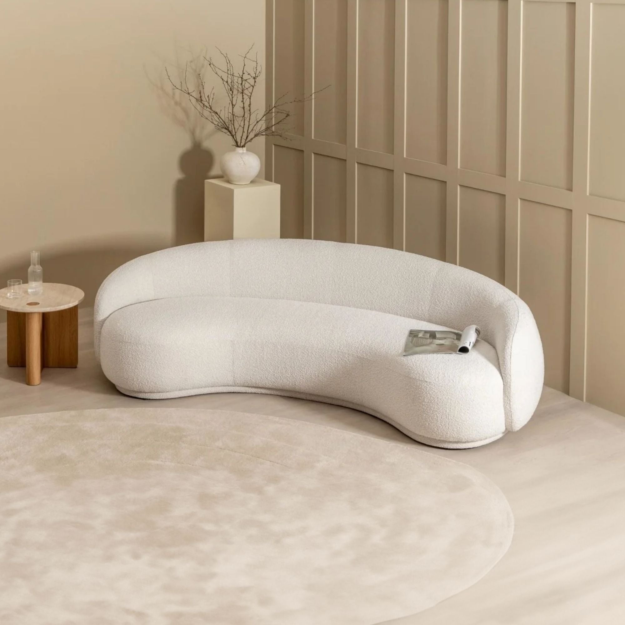 Modern white sofa in a minimalistic room with a neutral color palette.