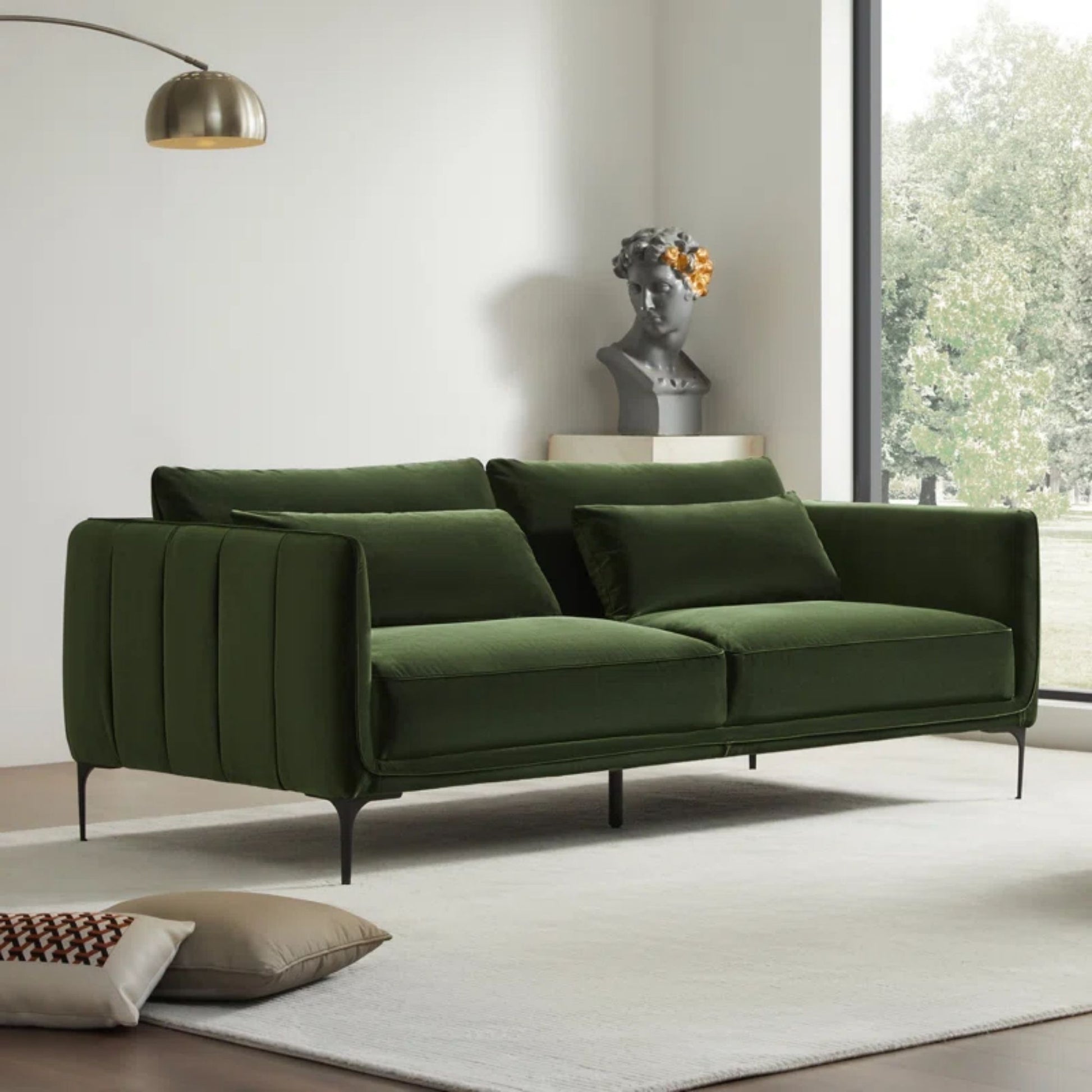 Green sofa in a modern living room with a white wall and window.