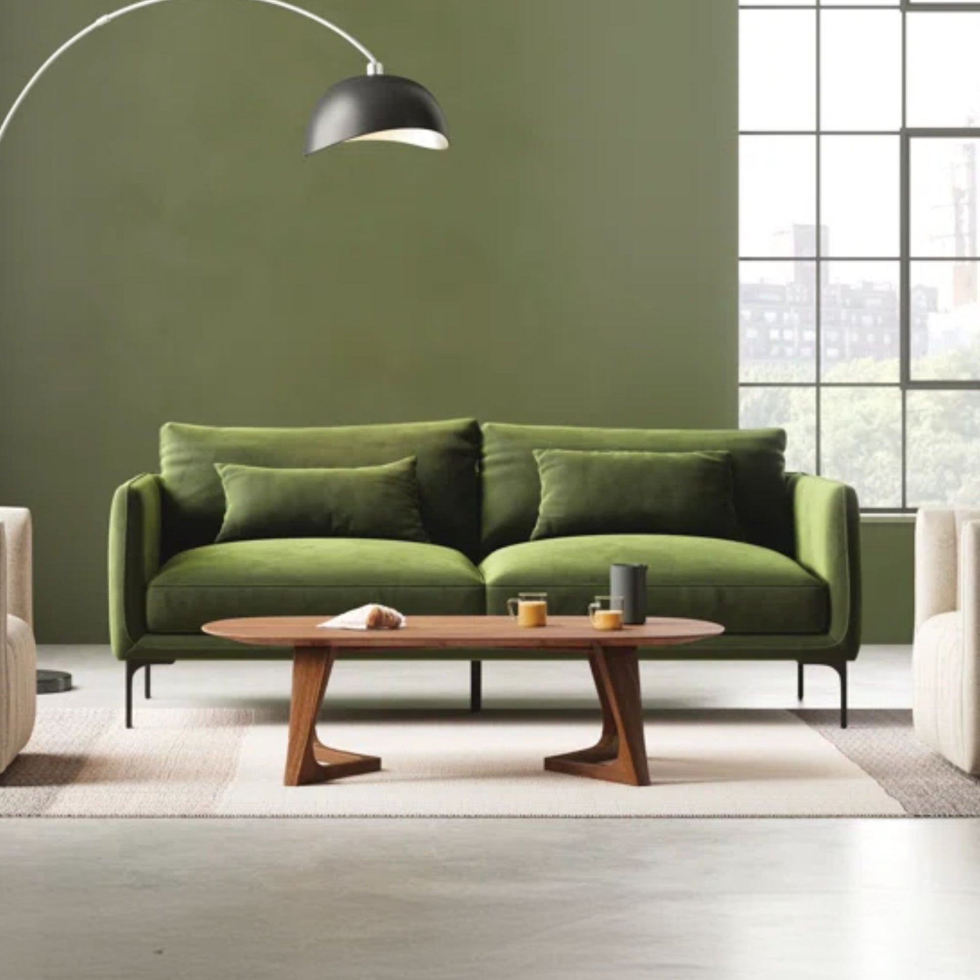Green sofa in a modern living room with a wooden coffee table and large window.