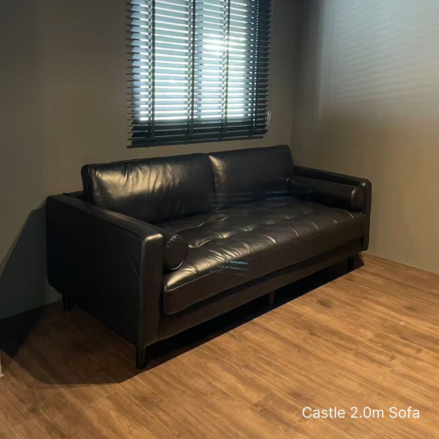 3 seater 200cm Castle black faux sofa in living room with wooden vinyl flooring and window 