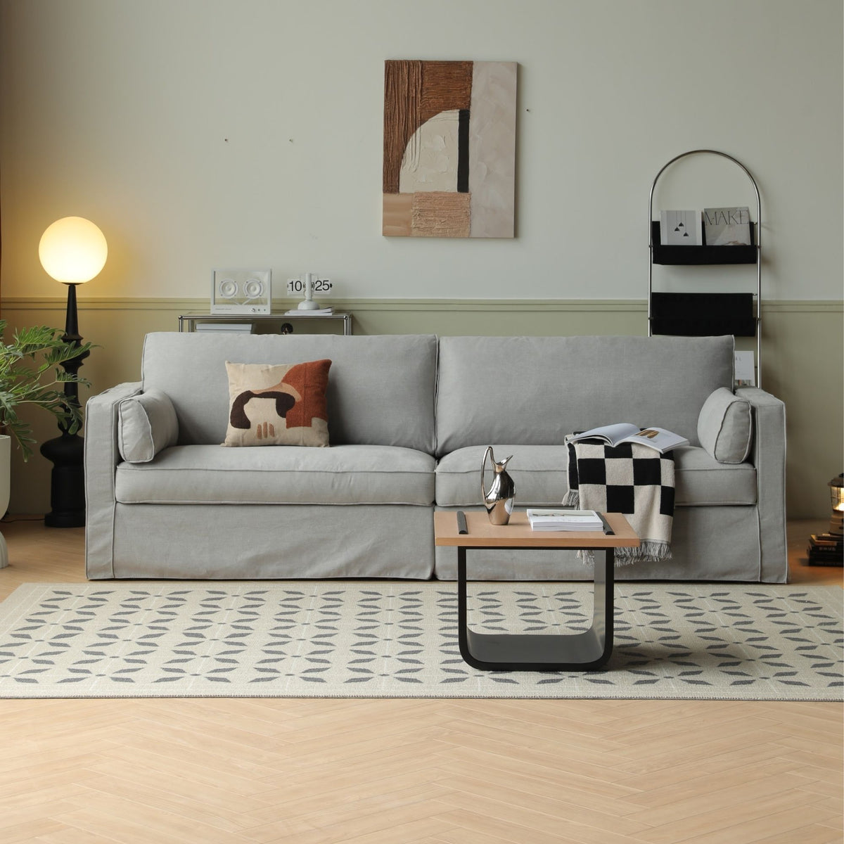 Celeste fabric sofa in grey in living room with plant, rug and wall painting