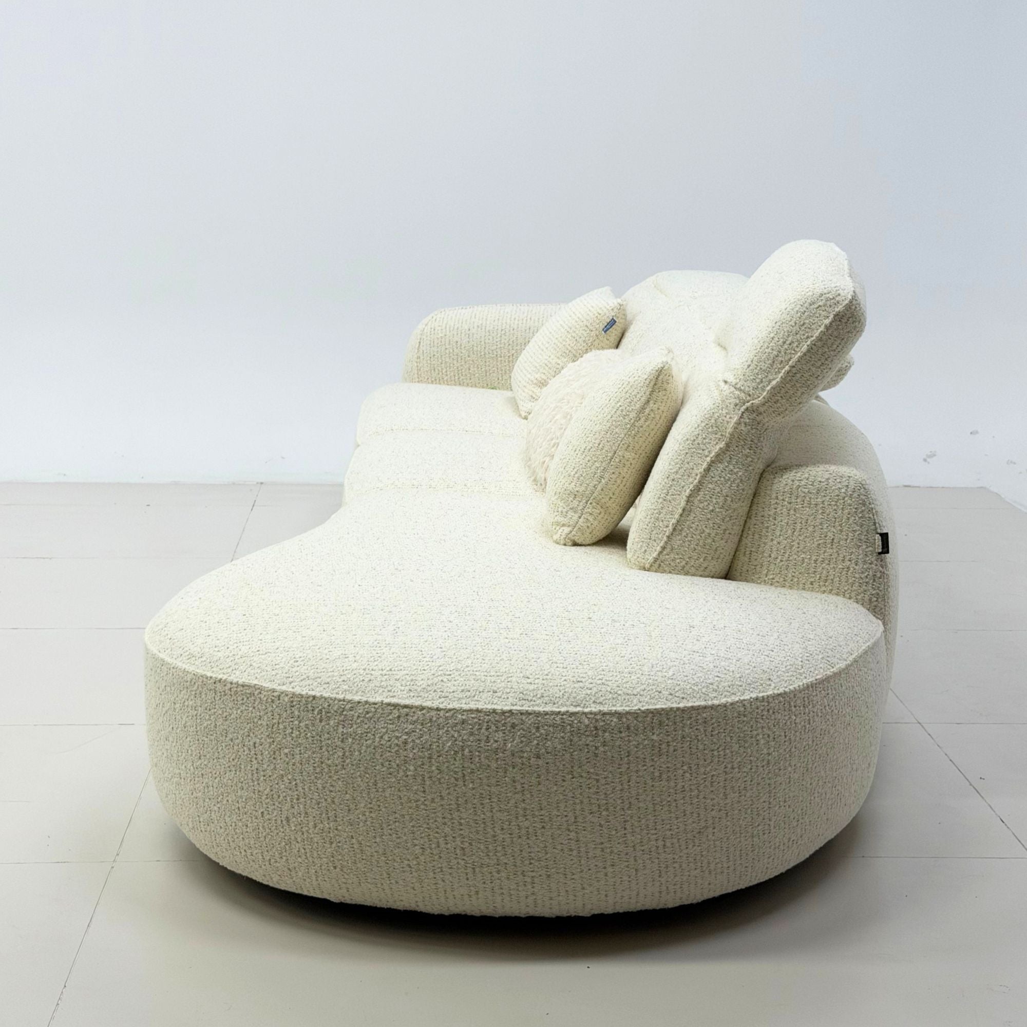 Side view of Celine fabric one arm sofa