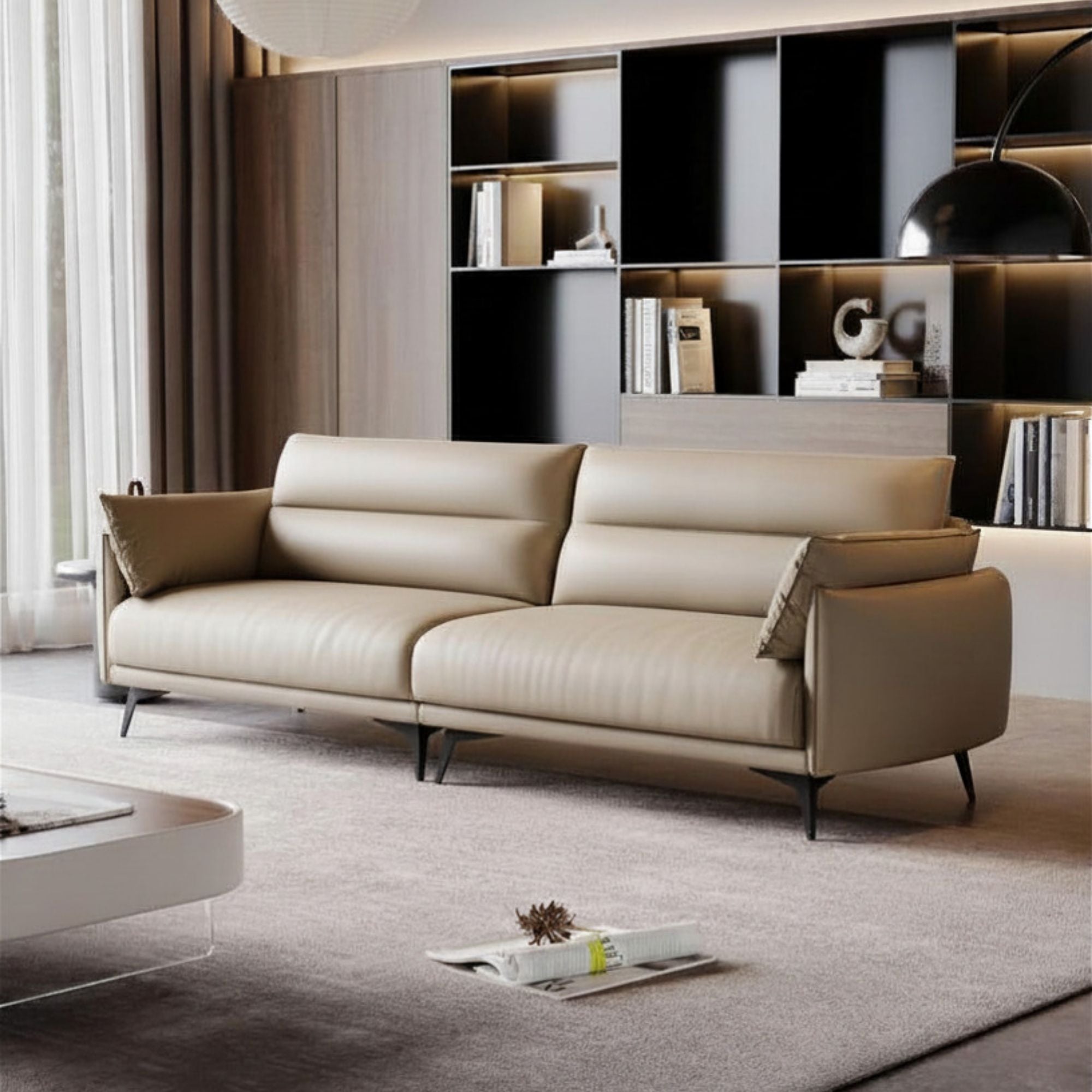 Beige sofa in a modern living room with a bookshelf in the background