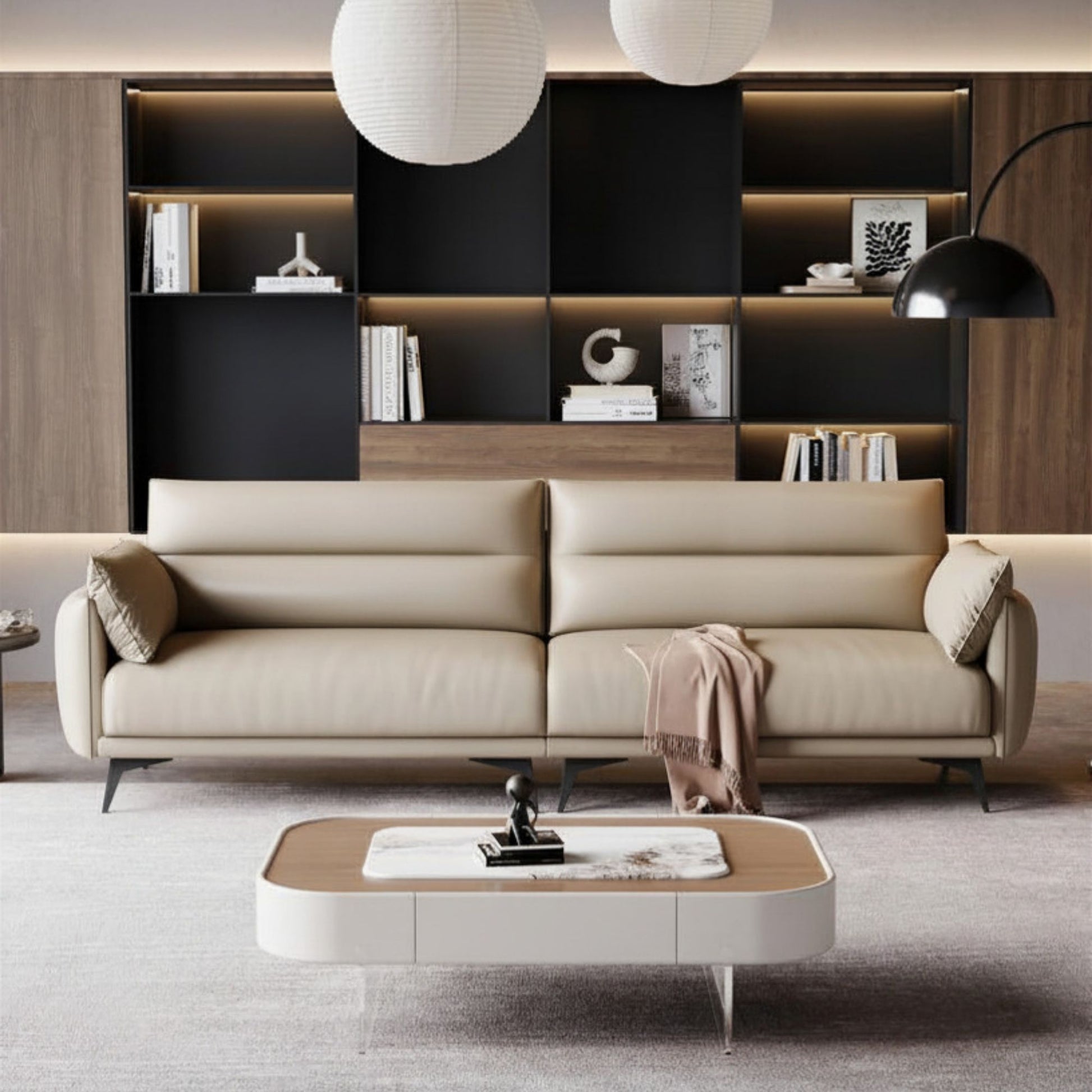 Modern living room with a beige sofa, coffee table, and bookshelf.
