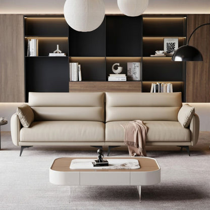 Modern living room with a beige sofa, coffee table, and bookshelf.