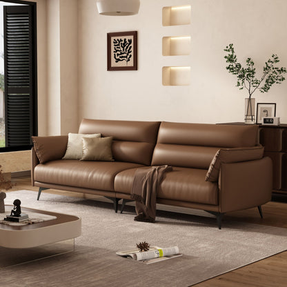 Brown leather sofa in a modern living room with decor elements.