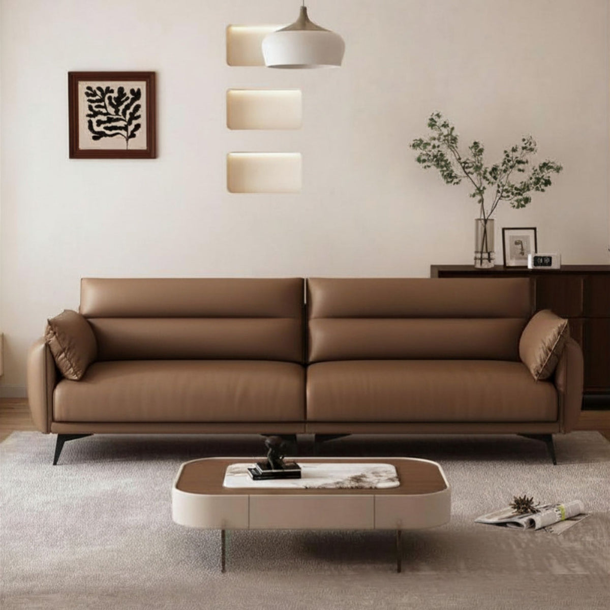Modern living room with a brown leather sofa, coffee table, and decorative elements.