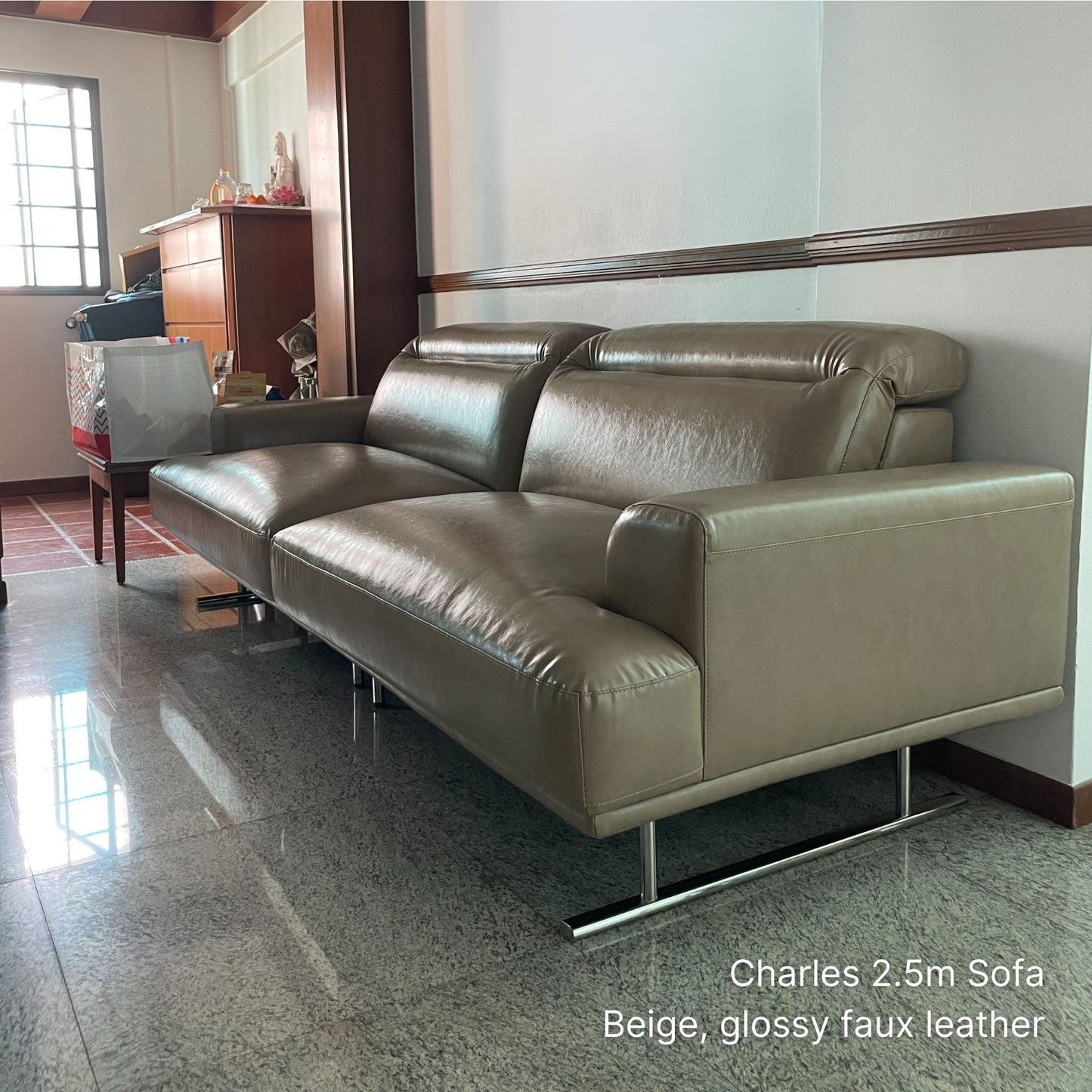 Beige 3 seater Charles faux leather sofa in a room with a mirror and wooden furniture.