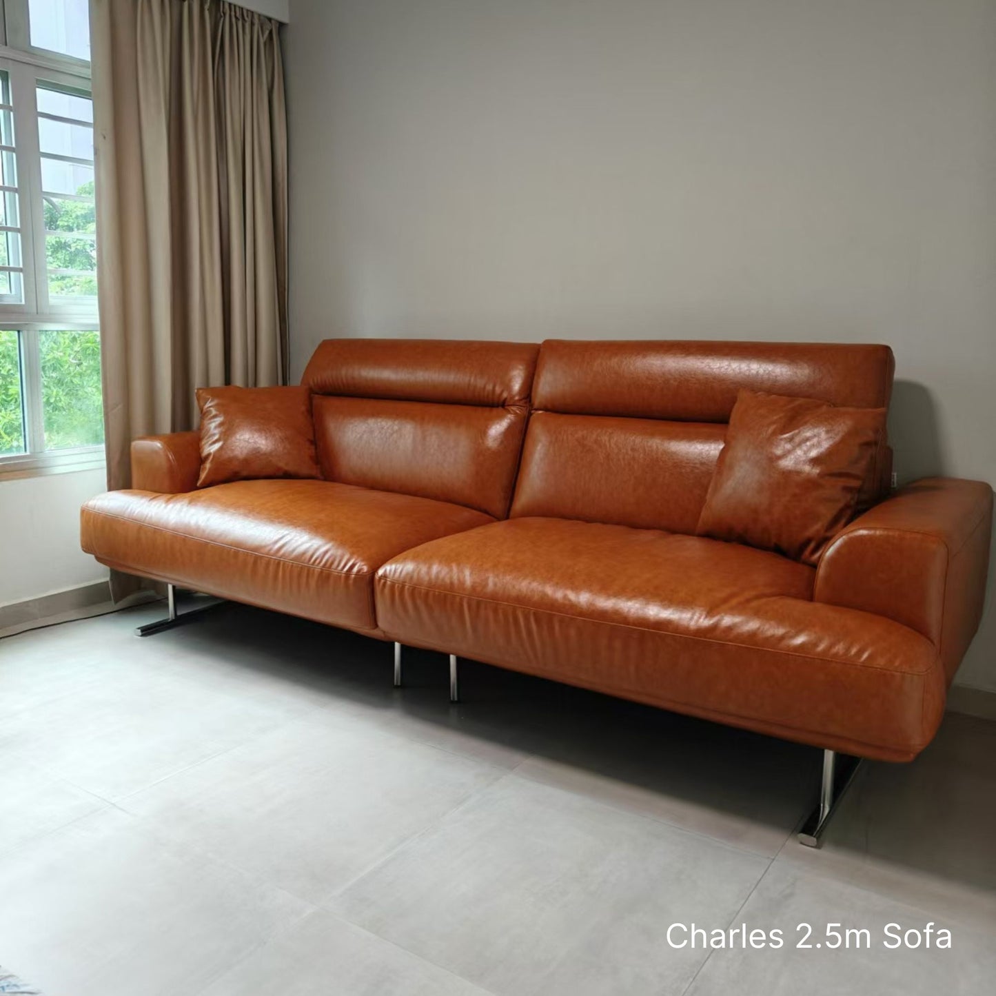 Brown 4 seater 250cm Charles faux leather sofa in a room with a window and curtains.