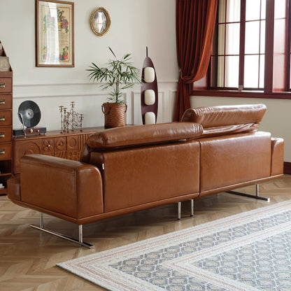 Brown leather sofa in a living room with decorative elements.