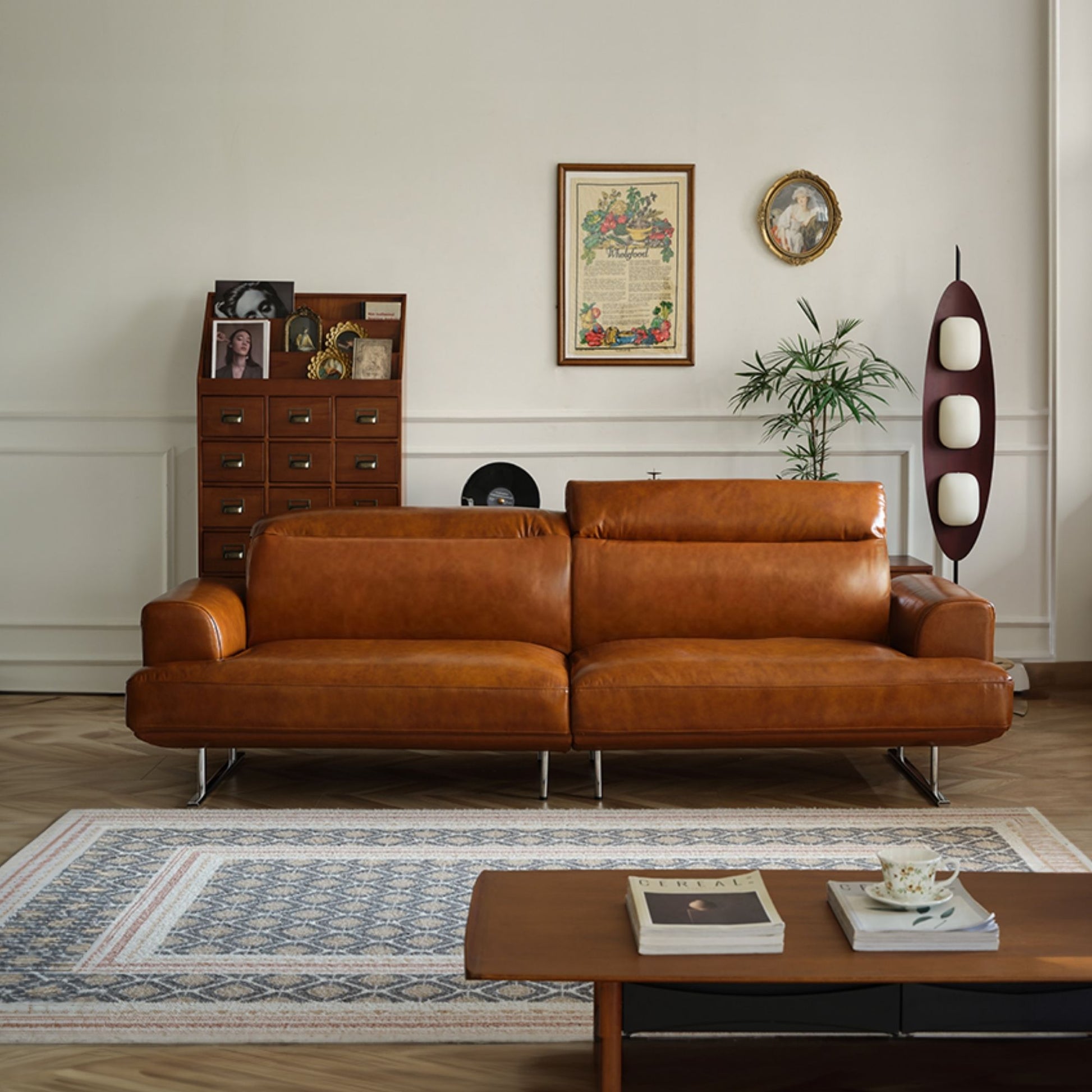 Brown leather sofa in a living room with a coffee table and decorative items.