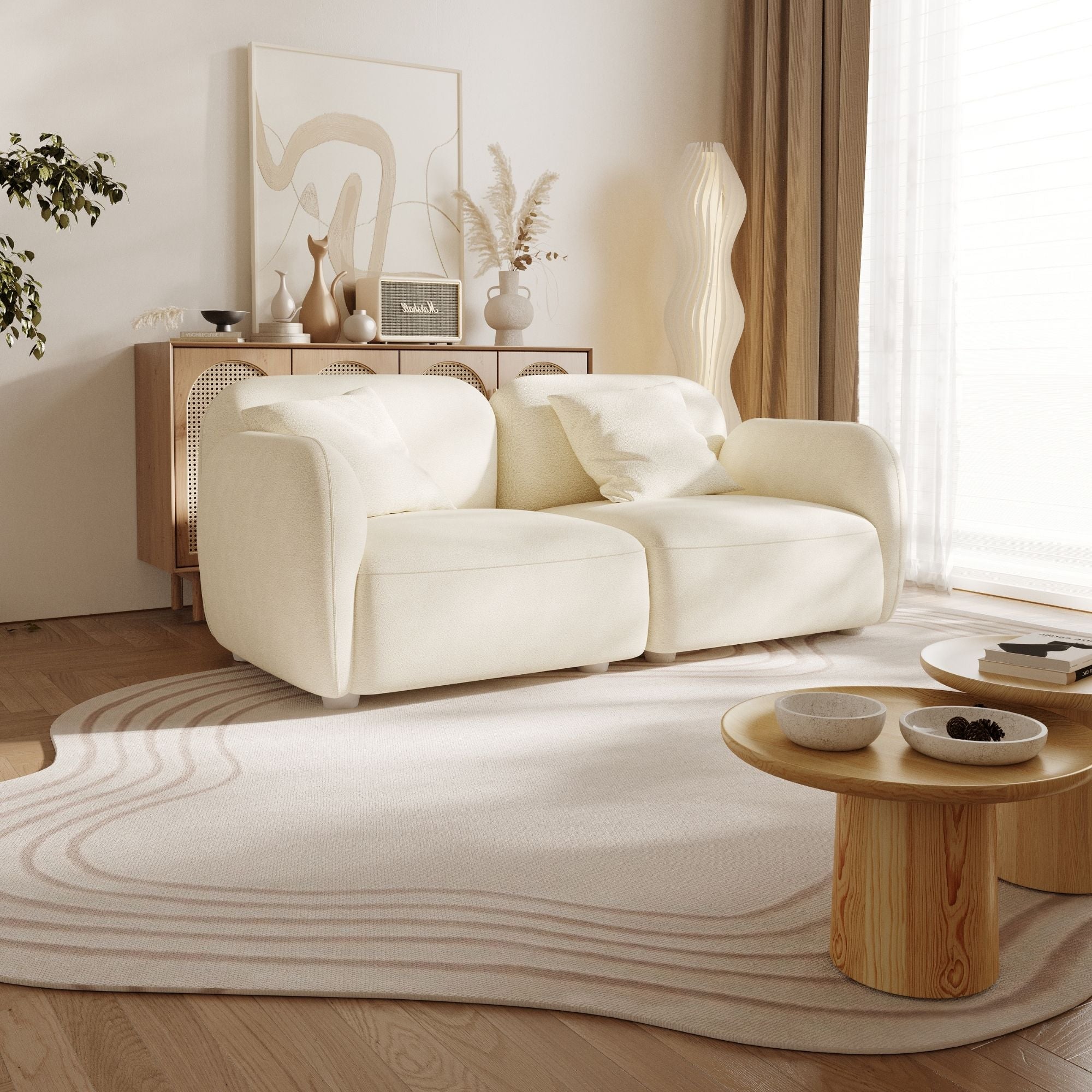 Modern living room with a white sofa, wooden coffee table, and decorative items.