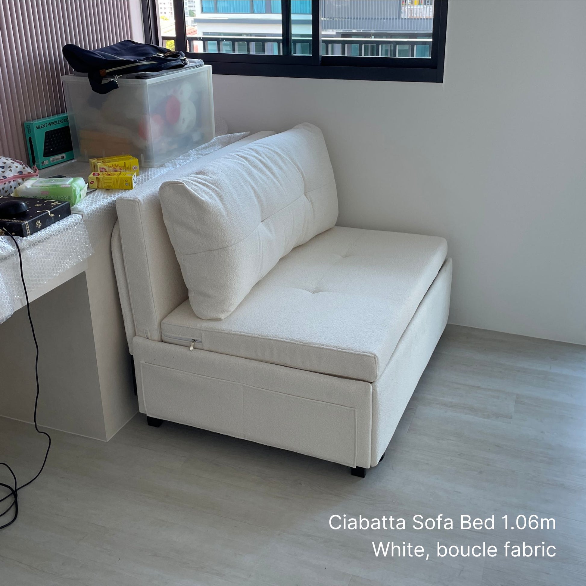 White sofa bed with boucle fabric in a room setting