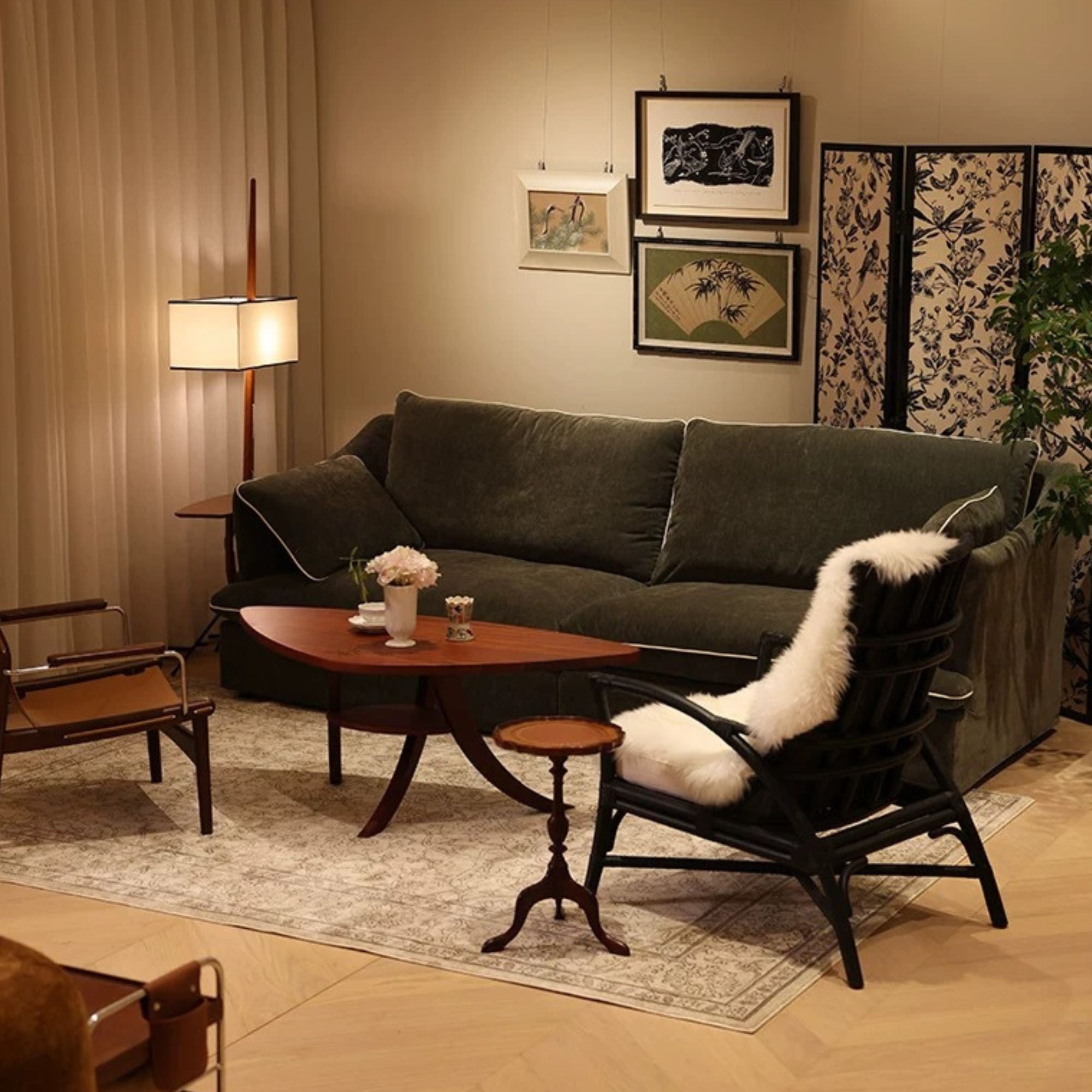Cozy living room with a dark green sofa, wooden coffee table, and armchair with a fur throw.