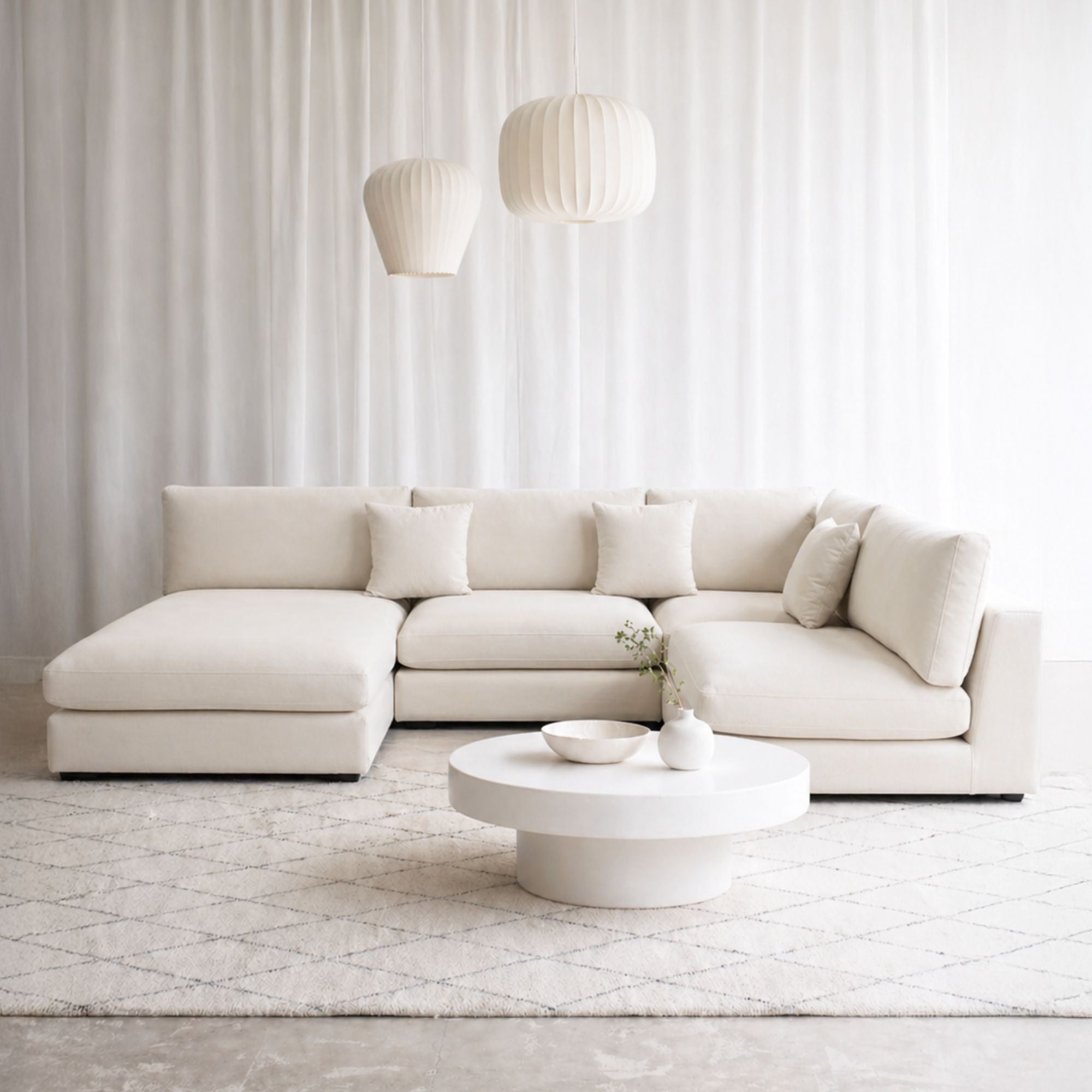 Claudia fabric u shaped sofa in default white in office setting with left chaise