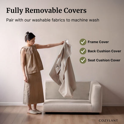 Woman holding a cover over a sofa with text about fully removable covers and machine washability.