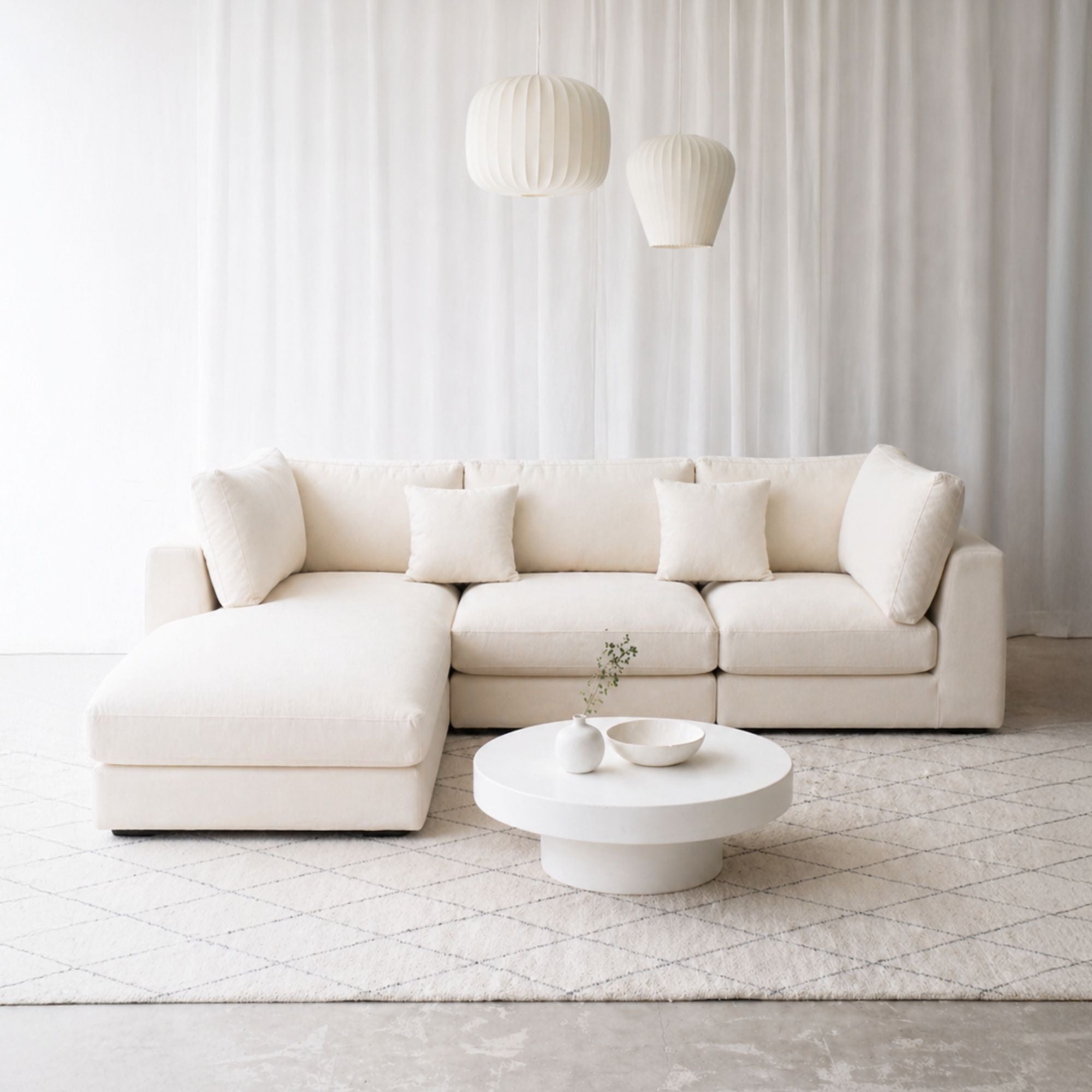 Claudia fabric l shape sectional sofa with chaise on the left in living room seting